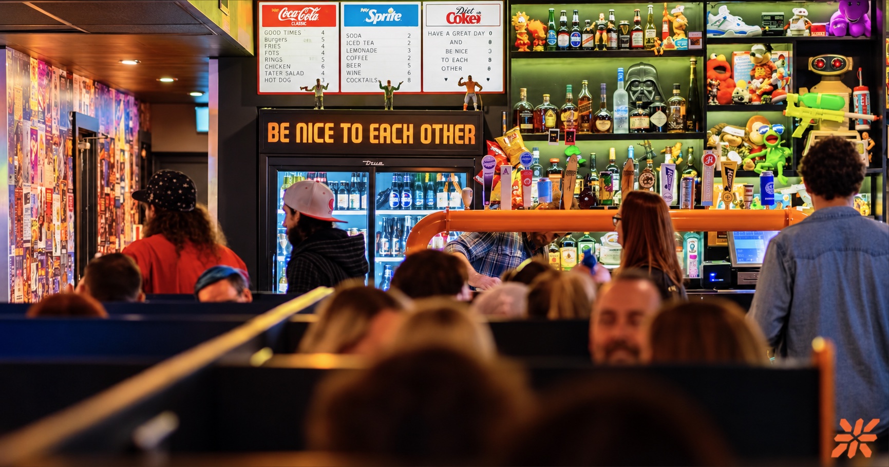 A busy night at the ZED*80 bar beneath the Be Nice to Each Other sign