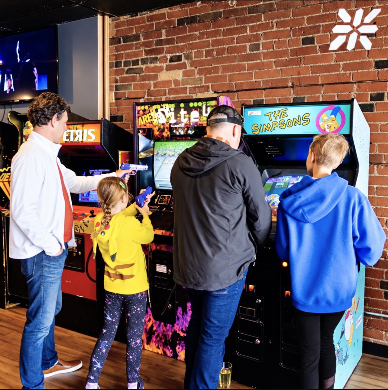 A family enjoying classic arcade games together at ZED*80
